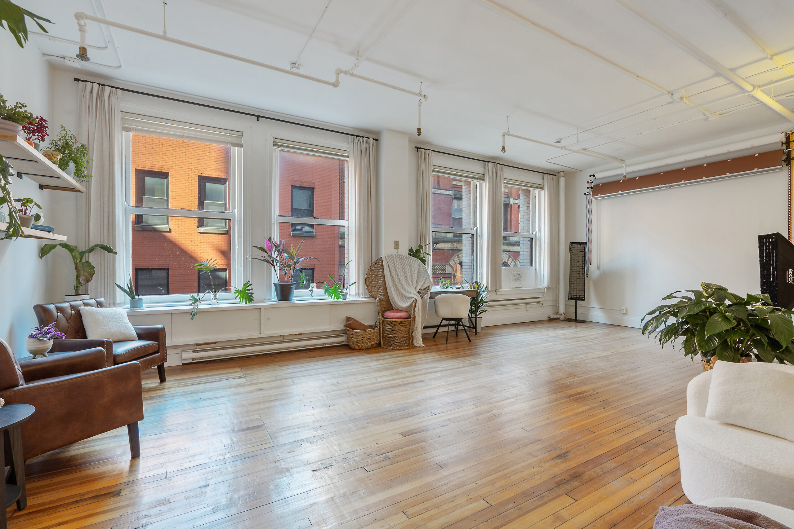 Natural light photo studio in Syracuse with lounge area and city view windows
