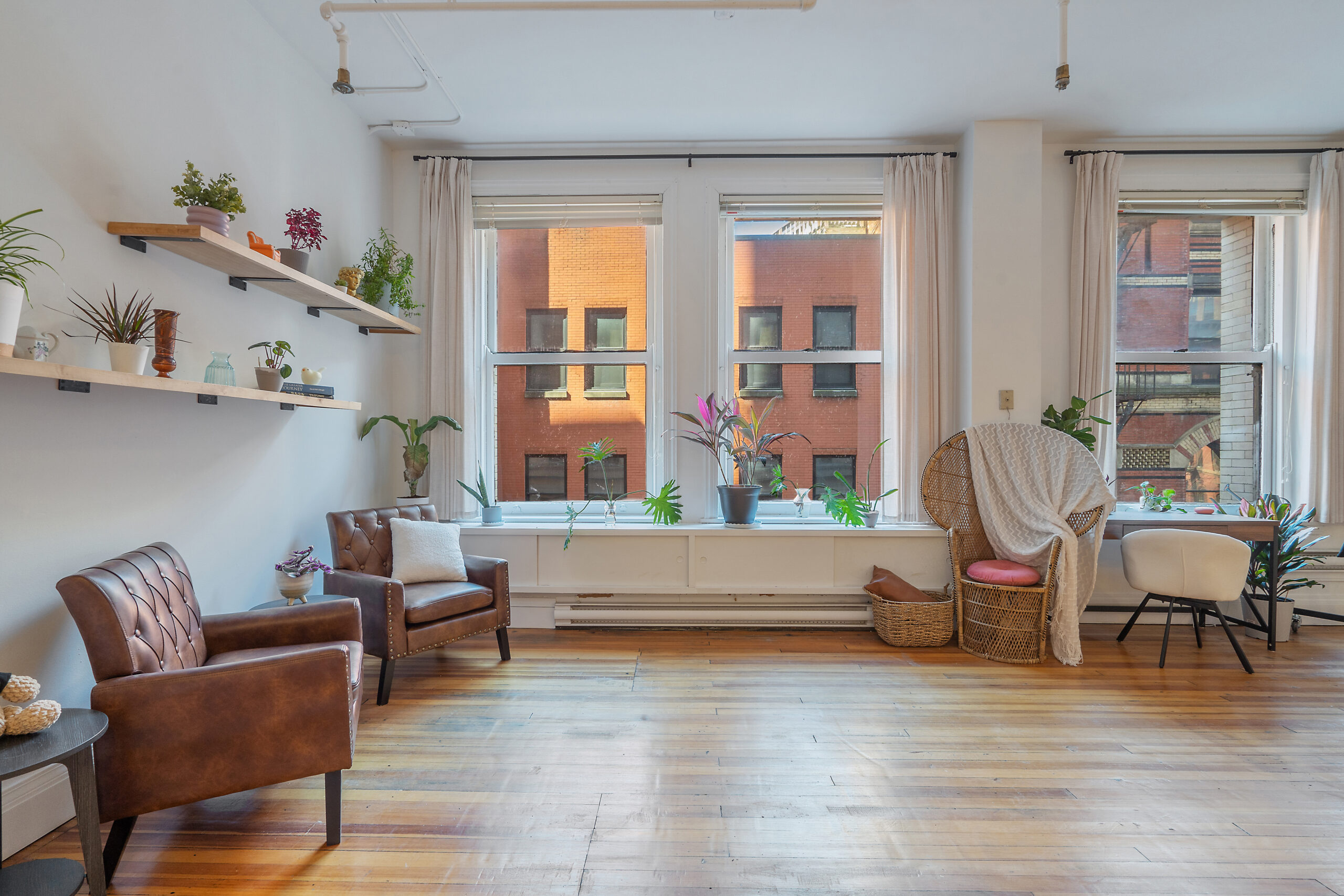 Natural light photo studio in Syracuse with cozy lounge seating and large windows