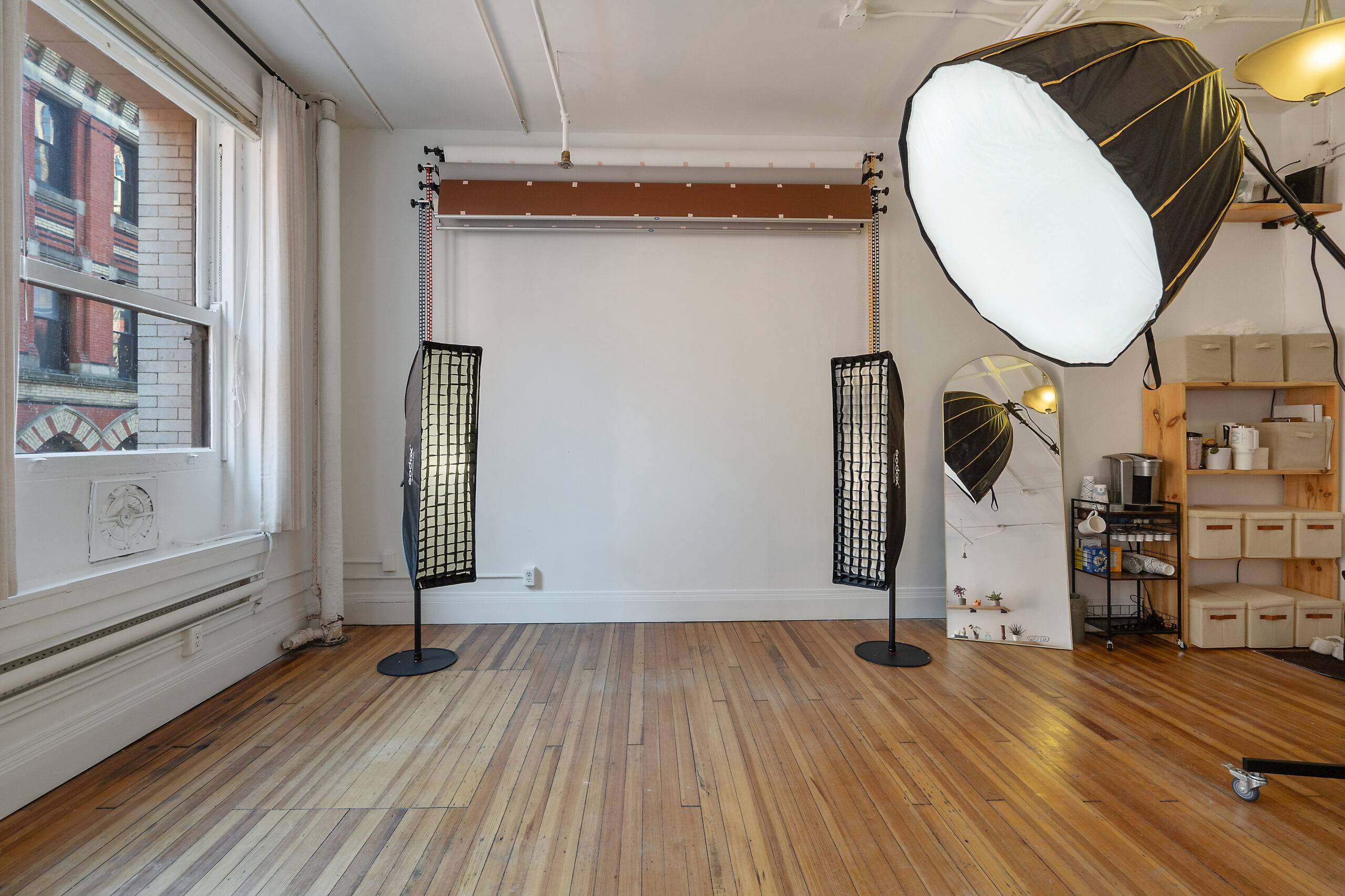 Natural light photo studio in Syracuse with white wall backdrop and softbox lighting