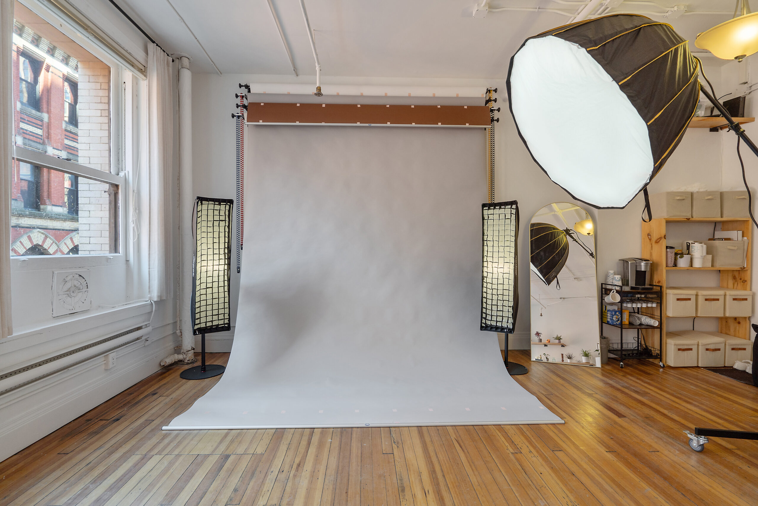 Natural light photo studio in Syracuse with seamless white backdrop and softbox lighting